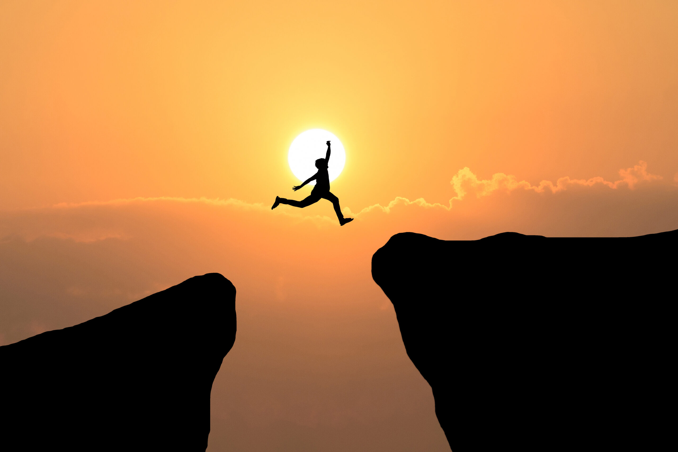 Courage Man Jump Through Gap Hill Business Concept Idea 3 Scaled